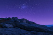 © PhotoArtHub - Starry night sky over rocky hill with vibrant purple tones