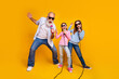 © deagreez - Happy family group singing karaoke on joyful yellow background
