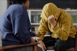 © Seventyfour - Portrait of unrecognizable teenage boy wearing hoodie and hiding face during meeting with therapist or school counsellor comforting him