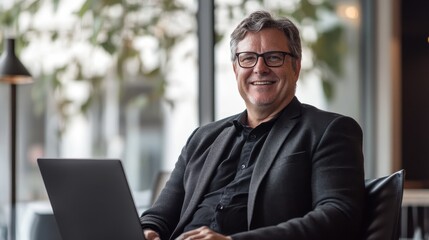Aufkleber - Professional man enjoying modern workspace while working on laptop with natural light