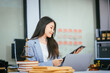 © NanSan - An Asian female lawyer conducts online consultations using a laptop in her office. She reviews legal contracts, advises clients, provides expert legal advice to businesses in Thailand, Japan,China
