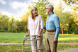 © New Africa - Senior couple with walking frame in park