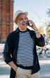 © BullRun - Happy mature man talking on smartphone in street