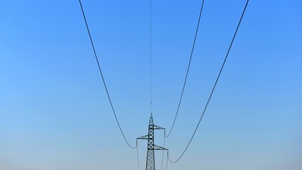 Power Lines: A 110 KV and a 220 KV high-voltage power line. Power transmission line pylons: High voltage electrical overhead lines on blue sky