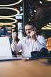 © BullRun - Accomplished male entrepreneur in optical eyewear celebrating triumph of web exchange on stock site,excited businessman feeling rejoice during working process in office room using laptop for marketing