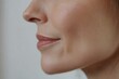 © SerPak - Close-up of young caucasian female's smooth, healthy skin and subtle smile.