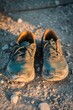 © SerPak - Weathered sneakers on rocky ground at sunset - outdoor adventure and durability concept.