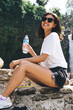 © BullRun - Delighted woman with bottle of water laughing