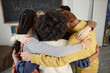 © Seventyfour - Closeup of teenage kids huddling with teacher in classroom during group motivational exercise in school