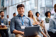© Drazen - Happy businessman using laptop during seminar in board room and looking at camera.