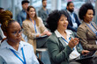 © Drazen - Happy female manager asking question from audience while participating in business seminar.