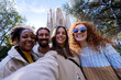 © Gigi Delgado - Multiracial group of happy tourists taking a selfie in Barcelona with sagrada familia in the background.