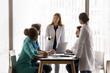 © fizkes - Diverse young healthcare specialists take part medical concilium led by Caucasian female hospital chief, make speech, explain treatment options, share experience, skills at briefing in clinic office