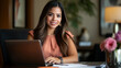 © Noah Lloyd - Professional Hispanic Woman Smiling While Working on a Laptop in an Elegant Office