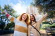 © CarlosBarquero - Portrait memories of young caucasian tourist women friends take photo at Sagrada Familia, Barcelona. Beautiful girls, street of European city looking camera. Vacation happy and smiling. tourism people