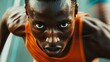 © Kenny - Focused african young male athlete sprinting with intensity in orange tank top