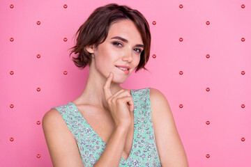 Wall Mural - Photo of coquettish young woman brown hair touch finger chin bite lips flirting stunning cunning posing isolated on pink color background