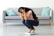 © Prostock-studio - Young Indian woman sitting on scales, upset over weight gain at home, copy space. Emotional Eastern woman dissatisfied with slimming results, fighting excess kilograms, panorama