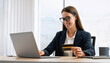 © venars.original - Young woman online shoping with credit card on laptop. Female freelancer connecting to internet via computer.