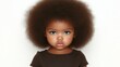© JO BLA CO - A young child with a full natural afro hairstyle stands against a plain background. Her serious expression and bright blue eyes capture a sense of innocence and curiosity