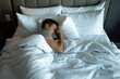 © kieferpix - Young sleepless man lying in bed feeling tired stressed