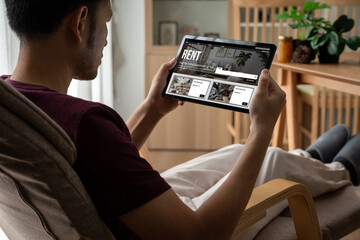 Online real estate rental search snugly on computer. House home or apartment rental website online.