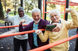© Marko Geber - Diverse senior men taking selfie while working out in park