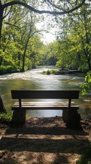 Wall Mural - A peaceful riverside bench with a view of gently flowing water, surrounded by trees and a soft breeze.