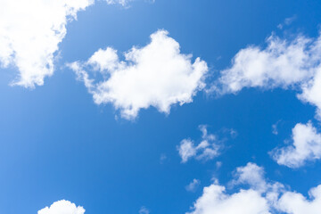 low angle view of beautiful blue sky with strange shape of fluffy white clouds in the morning or eve