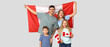 © Pixel-Shot - Happy family with flags of Canada on grey background