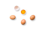 Closeup of brown organic free-range chicken eggs with broken egg isolated on a transparent background with shadow from above, top view