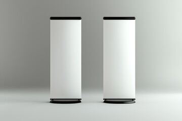 Wall Mural - Two photorealistic white roll-up banners on a smooth grey background, front view.