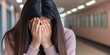© EpicFade - Young Woman Hiding Face in Hands Feeling Sadness Despair Loneliness in Corridor