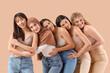 © Pixel-Shot - Group of young women hugging on beige background