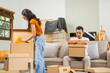 © M+Isolation+Photo - Young couple experiencing relationship issues,gathering belongings, packing items into box,engaging in arguments,expressing emotional frustration,seeking resolution,demonstrating tense body language
