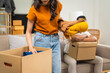 © M+Isolation+Photo - Young couple experiencing relationship issues,gathering belongings, packing items into box,engaging in arguments,expressing emotional frustration,seeking resolution,demonstrating tense body language