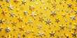 © InspireStock Gallery - A festive pattern of gold and silver stars scattered on a vibrant yellow background