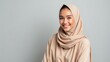 © ekalaila - Smiling Woman Wearing A Beige Hijab Against A Neutral Background