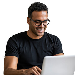 A smiling man with glasses uses a laptop computer appearing happy and focused on his work.