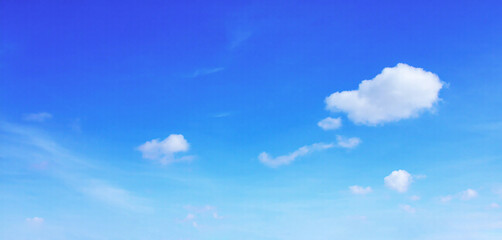 Wall Mural - clear sky with a few white clouds floating gently, bright and natural light,