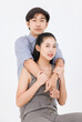 © Bangkok Click Studio - Portrait of young asian happy attractive cheerful couple love, Joyful sweethearts hugging embracing cuddle enjoy good time romantic date, posing to camera smiling sitting together on white background