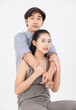 © Bangkok Click Studio - Portrait of young asian happy attractive cheerful couple love, Joyful sweethearts hugging embracing cuddle enjoy good time romantic date, posing to camera smiling sitting together on white background