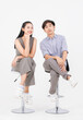 © Bangkok Click Studio - Portrait of lovely young asian happy attractive cheerful couple love, Joyful sweethearts enjoy good time romantic date, sitting on stools posing to camera smiling against together on white background.