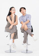 © Bangkok Click Studio - Portrait of lovely young asian happy attractive cheerful couple love, Joyful sweethearts enjoy good time romantic date, sitting on stools posing to camera smiling against together on white background.