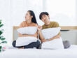 © Bangkok Click Studio - Portrait of young lovely sweet attractive asian happy couple love posing to camera smiling hugging pillow sitting on white bed in bedroom at home good time romantic together Valentine's day concept.