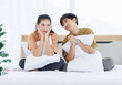 © Bangkok Click Studio - Portrait of young lovely sweet attractive asian happy couple love posing to camera smiling hugging pillow sitting on white bed in bedroom at home good time romantic together Valentine's day concept.