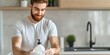 © TUN - Man Using Hand Soap in Modern Kitchen