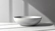© Kaizenart - Minimalist white bowl on a clean surface with soft shadows, creating a serene atmosphere