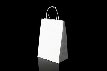 Recyclable craft paper bag for purchases, gifts and takeaway food mock up on black background. Environmentally friendly than single-use plastic bags