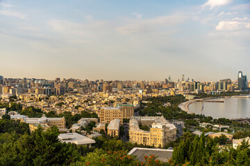 Wall Mural - A city view with a large body of water in the background. The city is full of tall buildings and the sky is clear